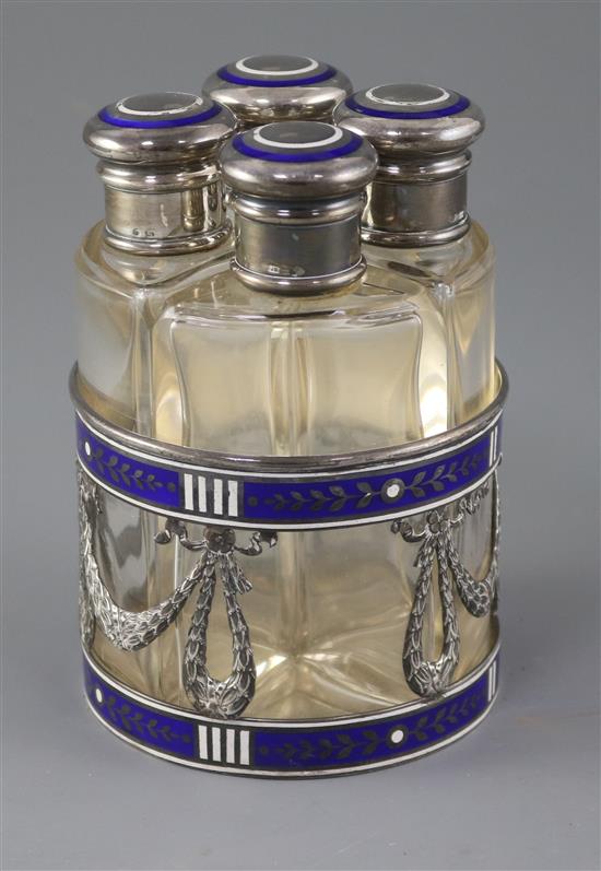 An early 20th century Austro-Hungarian silver and enamel mounted scent bottle stand fitted with four scent bottles,